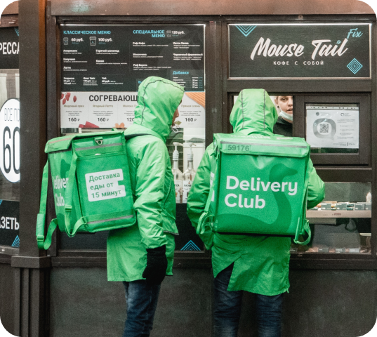 two delivery riders standing